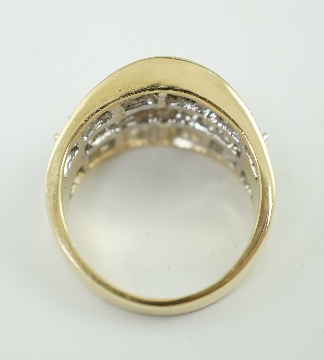 A modern 14k gold and three row baguette and round brilliant cut diamond set dress ring, based on the design of the Crown on the Statue of Liberty